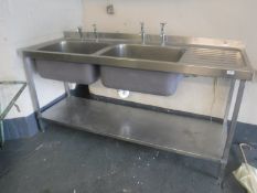 A stainless steel double sink with drainer