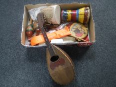 A box of assorted musical instruments including bowl backed mandolin, hand drums,