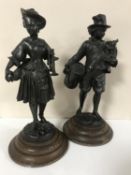 A pair of spelter figures depicting musicians on wooden plinths