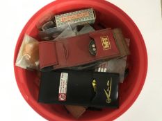 A collection of vintage dart flights, dart leather cases,