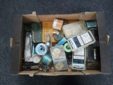A box containing fishing equipment including line, lures,