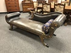 An Empire style studded leather scroll ended chaise with bolster cushion,