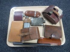 A tray containing hip flasks, clothes brushes in leather pouches, leather cased card set,