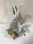 A Lladro figure of a donkey with flower together with a Nao figure of a swan