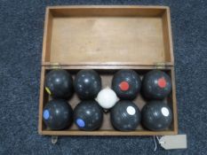A set of Banda mini lawn bowls in a fitted pine box