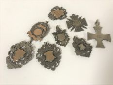 Seven silver pocket watch fobs and a silver cross dated 1902