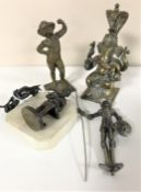 An early 20th century metal figure depicting Felix The Cat, together with four further bronze,
