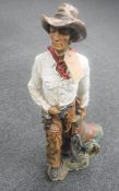 A large resin figure of a cowboy