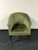 An Edwardian armchair upholstered in green dralon