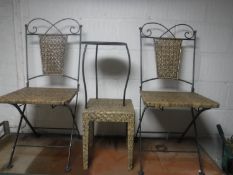 A pair of metal and wicker folding chairs, wicker side table,