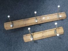 Five metal coat hooks mounted on two antique pine boards