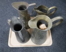 A tray of five copper and brass jugs