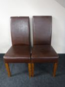 A pair of brown leather high back dining chairs