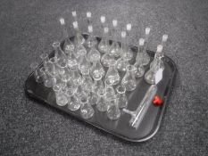 A tray of scientific glass beakers and test tubs
