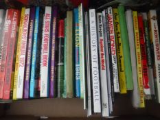 A box of annuals relating to football,