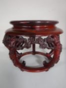 A circular carved hardwood oriental vase stand CONDITION REPORT: Section missing,