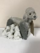 A Lladro figure of a poodle with puppies