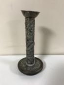 An early 20th century Chinese white metal candlestick with dragon decoration CONDITION
