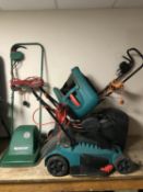 Three electric lawn mowers