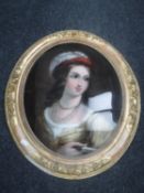 A 19th century reverse painting on glass, portrait of a lady wearing a red bonnet,