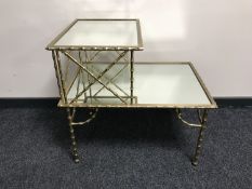 A brass mirrored telephone table