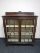 A glazed mahogany double door display cabinet