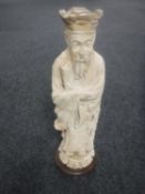 A 20th century Chinese stone figure on an Emperor with scroll, height 52cm,