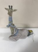 A Lladro figure of a giraffe with scarf CONDITION REPORT: In good condition. No box.
