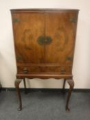 A Queen Anne style walnut cocktail cabinet,