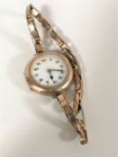 A lady's 9ct gold wristwatch on gold expanding strap CONDITION REPORT: 22.5g gross.