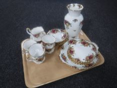 A tray containing a twenty-one piece Royal Albert Country Roses tea service,