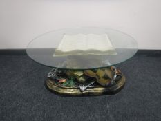 A contemporary glass topped coffee table on ornate base modelled as a violin resting on music books
