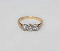 An 18ct gold three stone diamond ring, the central stone approximately 0.5ct, total approximately 1.