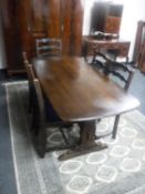 An Ercol refectory dining table and five oak ladder back chairs