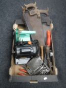 A box of vintage hand saws and tools and a polishing grinding machine