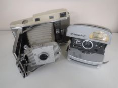 A vintage Polaroid camera and one other