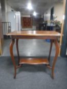 An Edwardian mahogany shaped occasional table