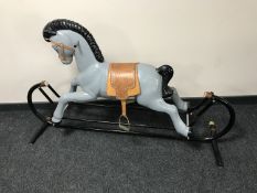 A 1970's plastic rocking horse, on metal base,