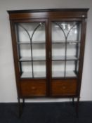 A Victorian inlaid mahogany double door display cabinet