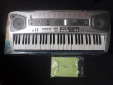 A Casio LK-55 electric keyboard in box