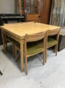 A mid 20th century pull out table and four chairs