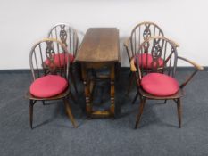 Four Ercol dining chairs and an oak gate leg table