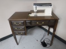 A Singer Futura electric sewing machine in oak table
