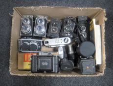 A box of twin-lens reflex cameras with lens and accessories