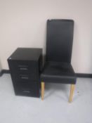 A black leather dining chair and a three drawer metal filing chest