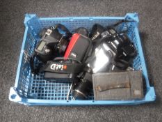 A basket containing assorted cameras including a Minolta Dynax 3000i, Pentax ISTD,