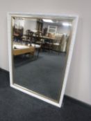 A contemporary white and gilt framed overmantel mirror