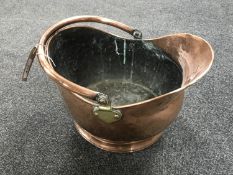 An antique copper and brass coal bucket