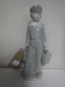 A Lladro figure - boy carrying water buckets