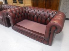 A red leather two seater Chesterfield settee (no cushions)